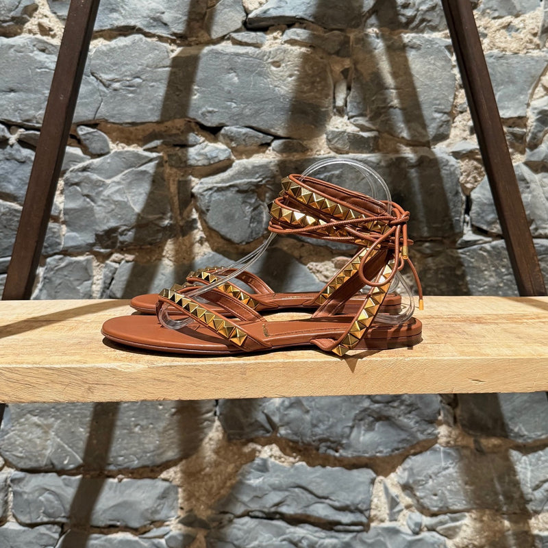 A side view of Valentino Brown Leather Gold Studded No Limit Gladiator Flat Sandals