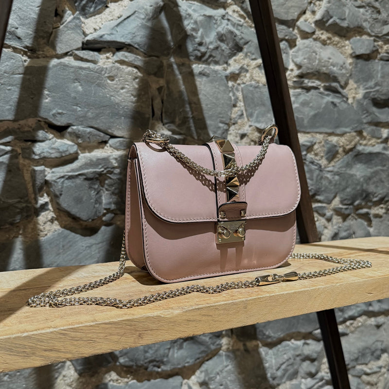 Side front view of Valentino Poudre Pink Leather Small Glam Lock Chain Bag