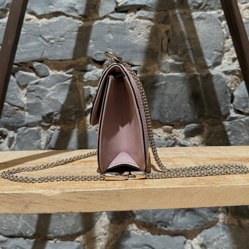 A side view of Valentino Poudre Pink Leather Small Glam Lock Chain Bag
