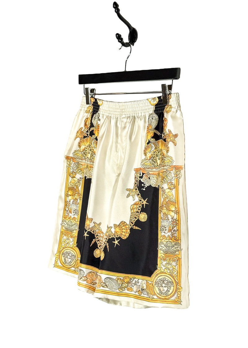 Side front view of Versace Coral Theatre Print White Gold Silk Jogger Shorts