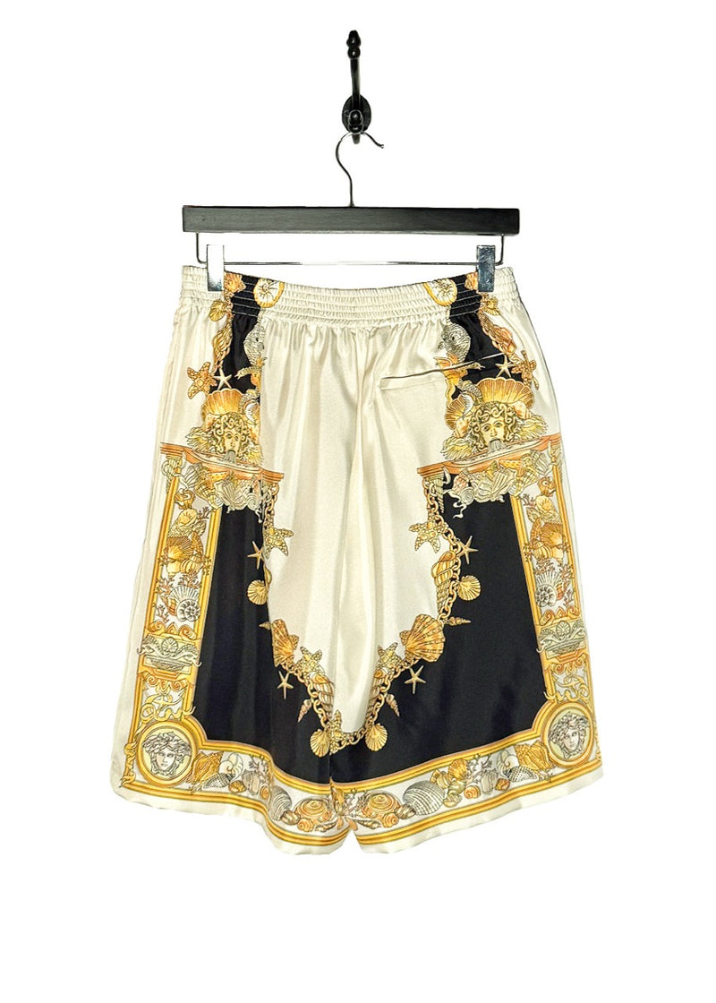 Back view of Versace Coral Theatre Print White Gold Silk Jogger Shorts
